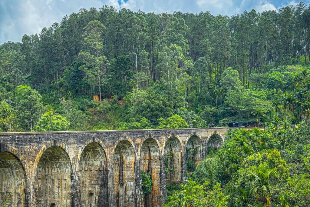 Nine Arches Bridge stretches through dense green rainforest in Sri Lanka 